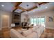 Cozy living room with fireplace, hardwood floors, modern furniture, and sliding glass doors to outdoor space at 724 Ideal Way, Charlotte, NC 28203