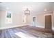 Bright living room with hardwood floors, modern chandelier, and neutral paint, perfect for relaxation at 724 Ideal Way, Charlotte, NC 28203