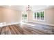 Sunlit living room features wood floors, a modern light fixture, and sliding doors leading to an outdoor patio at 724 Ideal Way, Charlotte, NC 28203