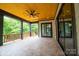 Relax on this covered patio with wood ceiling, ceiling fan and great views of the backyard at 724 Ideal Way, Charlotte, NC 28203