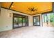 Entertain on this spacious patio with wood ceiling and backyard views through glass doors at 724 Ideal Way, Charlotte, NC 28203
