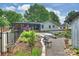 Secluded backyard includes beautiful landscaping, a modern in-ground pool, and an outdoor dining space at 742 Lansdowne Rd, Charlotte, NC 28270