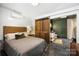 Comfortable bedroom featuring shiplap walls, barn door leading to ensuite bathroom, creating a cozy retreat at 742 Lansdowne Rd, Charlotte, NC 28270