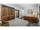 Bright bedroom featuring a barn door, dresser and unique art creating a cozy and stylish space at 742 Lansdowne Rd, Charlotte, NC 28270