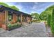 Inviting brick home porch featuring stone pavers, wood columns, and stylish decor at 742 Lansdowne Rd, Charlotte, NC 28270