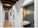 Hallway with wooden ceiling beams and a bathroom with modern sink and decorative wall at 742 Lansdowne Rd, Charlotte, NC 28270