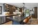 Gourmet kitchen featuring a large island, wooden cabinetry, modern appliances, and designer lighting at 742 Lansdowne Rd, Charlotte, NC 28270