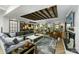 Spacious living room featuring a comfortable couch, decorative rug, and ceiling with exposed wooden beams at 742 Lansdowne Rd, Charlotte, NC 28270