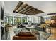 Bright and airy living room with wood floors, coffered ceilings, and expansive windows at 742 Lansdowne Rd, Charlotte, NC 28270