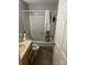 Modest bathroom features a shower-tub combo with white tile surround and neutral vanity at 7539 Holly Grove Ct, Charlotte, NC 28227