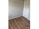 Simple bedroom with wood-look floors and a door leading to a closet at 7539 Holly Grove Ct, Charlotte, NC 28227