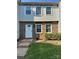 Charming townhouse featuring a brick facade, white door, and well-maintained landscaping at 7539 Holly Grove Ct, Charlotte, NC 28227