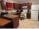 Functional kitchen with stainless steel sink, white appliances and ample counter space at 7539 Holly Grove Ct, Charlotte, NC 28227