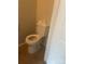 This outdated toilet sits on a brown tile floor and is ready for replacement at 7539 Holly Grove Ct, Charlotte, NC 28227
