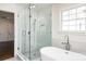 Bright bathroom featuring a glass shower, soaking tub, and modern fixtures at 754 Wriston Pl, Charlotte, NC 28209
