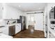 Bright, white kitchen with stainless steel appliances and barn door at 754 Wriston Pl, Charlotte, NC 28209