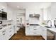 Modern kitchen featuring white cabinets, stainless steel appliances, and marble countertops at 754 Wriston Pl, Charlotte, NC 28209