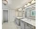 Bright bathroom with double vanities, neutral colors, and decorative chandelier at 7809 Greenfield Dr, Charlotte, NC 28270