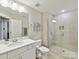 Contemporary bathroom with glass shower and vanity with white countertop at 7809 Greenfield Dr, Charlotte, NC 28270