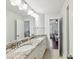 Bathroom with double sink vanity, granite countertops, and views to bedrooms at 7809 Greenfield Dr, Charlotte, NC 28270