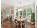 Eat-in kitchen area featuring a breakfast table, large windows, and hardwood floors at 7809 Greenfield Dr, Charlotte, NC 28270