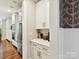 This kitchen has white cabinetry and stainless steel appliances with wood floors at 7809 Greenfield Dr, Charlotte, NC 28270