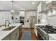 Open kitchen featuring white cabinetry, stainless steel appliances, and a spacious island with a sink at 7809 Greenfield Dr, Charlotte, NC 28270