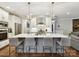 Bright and modern kitchen with pendant lighting, an island with seating, and stainless steel appliances at 7809 Greenfield Dr, Charlotte, NC 28270