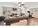 Spacious living room with hardwood floors, a grey sofa, and a ceiling fan at 7809 Greenfield Dr, Charlotte, NC 28270