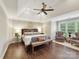 Spacious main bedroom with hardwood floors, tray ceiling, and a seating area with large windows at 7809 Greenfield Dr, Charlotte, NC 28270