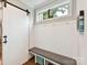 Mudroom with a sliding barn door and coat hooks at 7809 Greenfield Dr, Charlotte, NC 28270