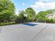 Enjoy a game of basketball or soccer on your own private sports court, fully fenced and ready for fun and recreation at 7809 Greenfield Dr, Charlotte, NC 28270