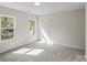 Bedroom featuring two windows and neutral carpeting at 808 Carolyn Ave, Kannapolis, NC 28083