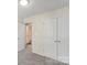 Bedroom featuring neutral carpeting, a view into the bathroom, and a double door closet at 808 Carolyn Ave, Kannapolis, NC 28083