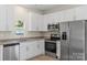 Modern kitchen with stainless steel appliances, granite countertops, and white cabinets at 808 Carolyn Ave, Kannapolis, NC 28083