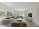 Bright living room with modern furnishings, wood floors, and plenty of natural light at 808 Carolyn Ave, Kannapolis, NC 28083