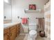 Bathroom featuring oak cabinets, light tile flooring and countertops, and a shower with striped curtain at 8801 Chinaberry Ln, Concord, NC 28027