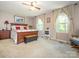 Spacious bedroom with wood furniture, neutral carpeting, and bright natural light from large windows at 8801 Chinaberry Ln, Concord, NC 28027