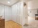 Hallway featuring a wall of white closets with access to other rooms in the home at 8801 Chinaberry Ln, Concord, NC 28027