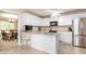 Bright, open kitchen with white cabinets, granite countertops and stainless steel appliances at 8801 Chinaberry Ln, Concord, NC 28027
