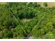 Aerial view showing lot lines of a wooded property with a home nestled among the trees at 9941 Heritage Oak Ln, Waxhaw, NC 28173