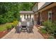 Cozy back patio with brick pavers, chairs, a fire pit, and a nearby deck at 9941 Heritage Oak Ln, Waxhaw, NC 28173