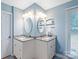 Bathroom featuring double vanity with granite countertops, matching oval mirrors, and tile flooring at 9941 Heritage Oak Ln, Waxhaw, NC 28173