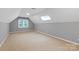 Cozy bedroom with skylight and window, carpeted for warmth and comfort at 9941 Heritage Oak Ln, Waxhaw, NC 28173
