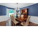 Elegant dining room with blue walls, a bay window, and a classic wooden table at 9941 Heritage Oak Ln, Waxhaw, NC 28173