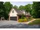 Charming home with a two-car garage, gravel driveway, and mature landscaping at 9941 Heritage Oak Ln, Waxhaw, NC 28173