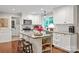 Charming kitchen features a center island, white cabinets, stainless steel appliances, and granite countertops at 9941 Heritage Oak Ln, Waxhaw, NC 28173