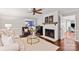Cozy living room with a fireplace, neutral tones, and view to dining room, creating a warm ambiance at 9941 Heritage Oak Ln, Waxhaw, NC 28173