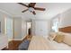 Bedroom boasts a ceiling fan, hardwood floors, and access to an ensuite bathroom at 9941 Heritage Oak Ln, Waxhaw, NC 28173