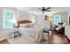 Cozy main bedroom featuring a wicker headboard, ceiling fan, and lots of natural light from the windows at 9941 Heritage Oak Ln, Waxhaw, NC 28173